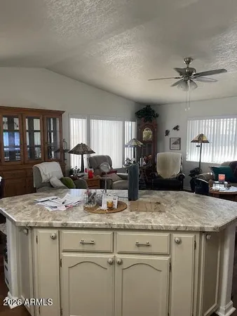 a kitchen with granite countertop a sink a counter top space appliances and cabinets