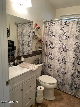 a bathroom with a toilet and a shower curtain