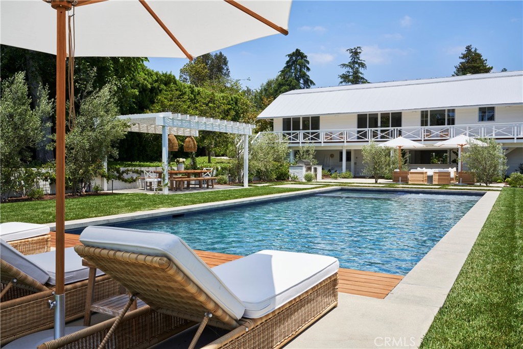 an outdoor space with swimming pool and furniture