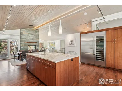 a large kitchen with stainless steel appliances granite countertop a lot of counter space and wooden floor