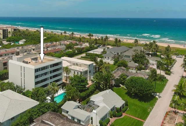 an aerial view of residential houses with outdoor space and street view