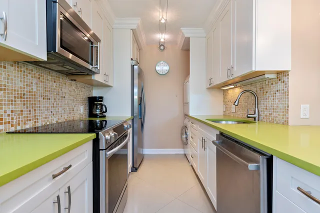 a kitchen with stainless steel appliances granite countertop a sink and a stove top oven