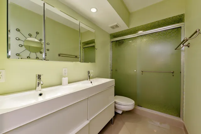 a bathroom with a granite countertop sink a toilet and a bathtub