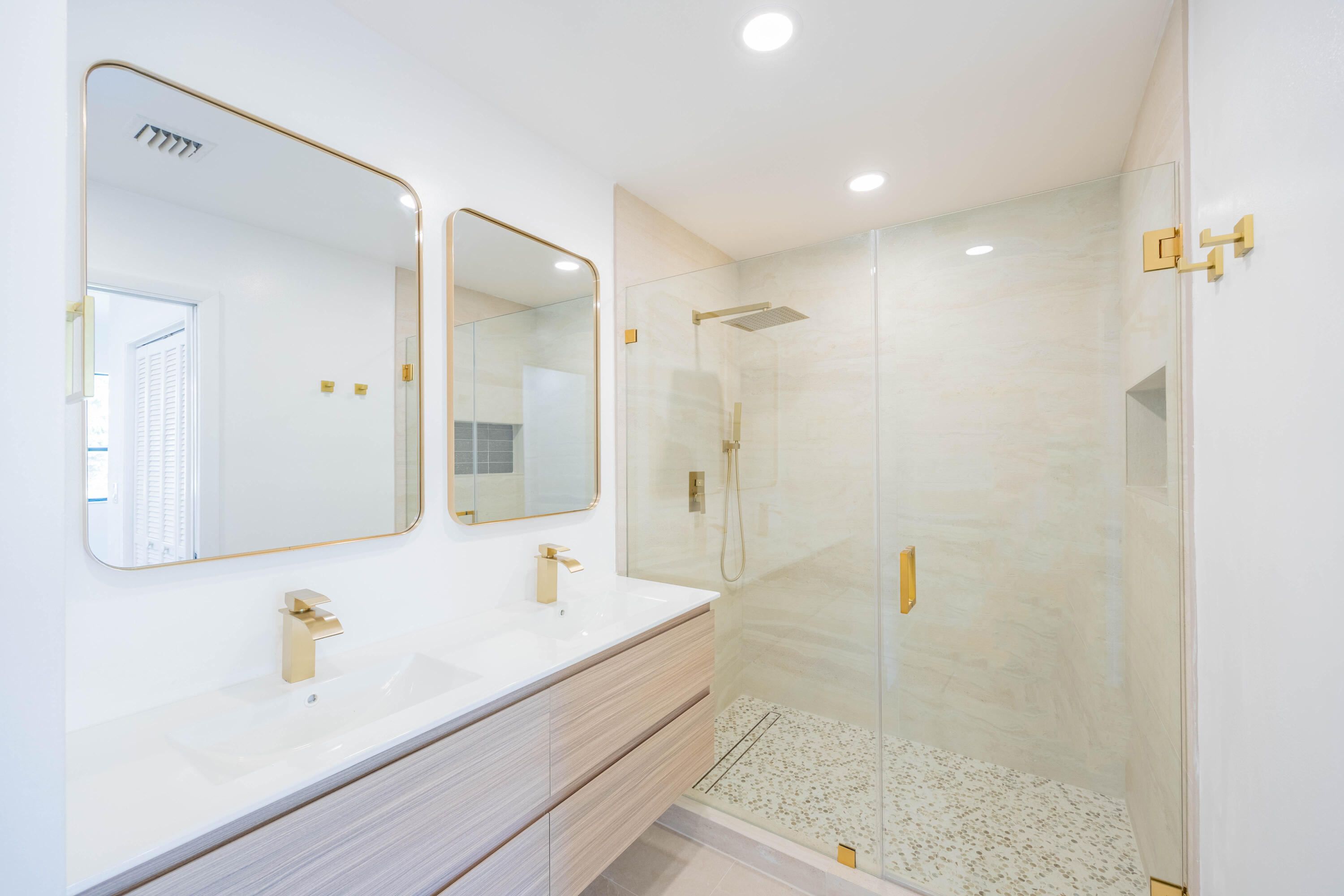 7520 La Paz Boulevard, Unit 104 Boca Raton, FL 33433 - Photo 28 of 56 a bathroom with a bathtub shower sink and mirror