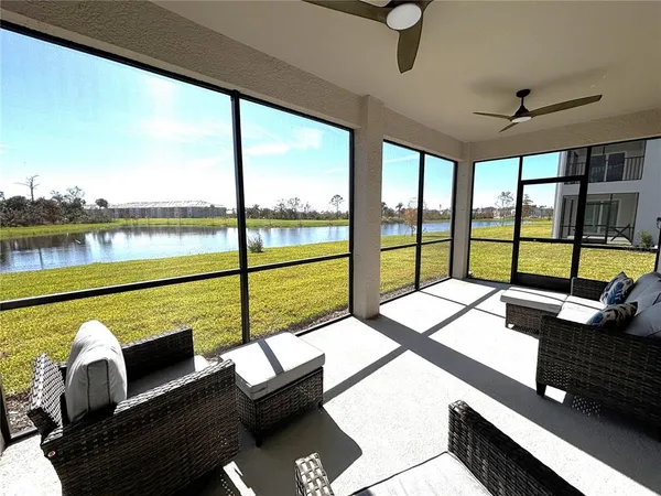 a bedroom with furniture and large windows