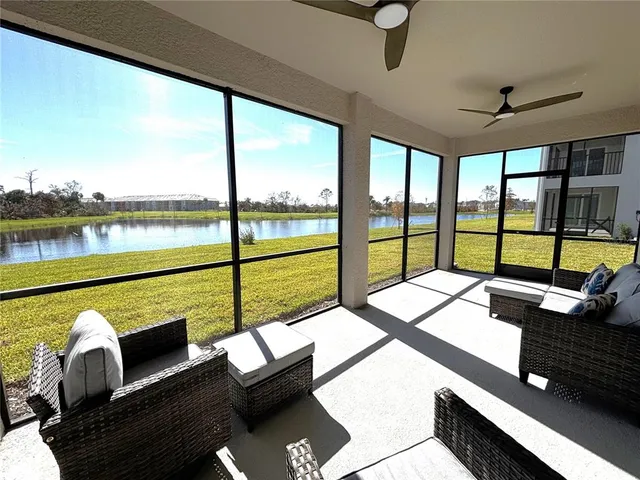 a bedroom with furniture and large windows