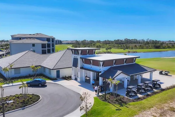 an aerial view of a house with swimming pool and a yard