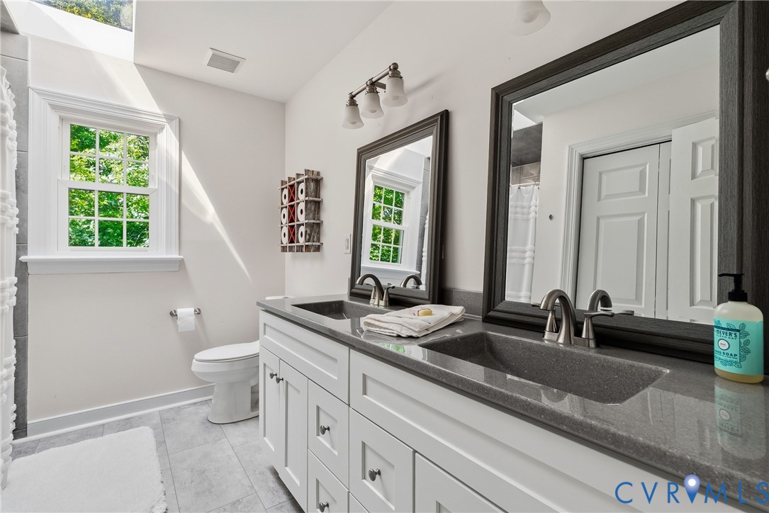 14321 Crossings Ridge Drive Midlothian, VA 23113 - Photo 29 of 43 a bathroom with double vanity and a mirror