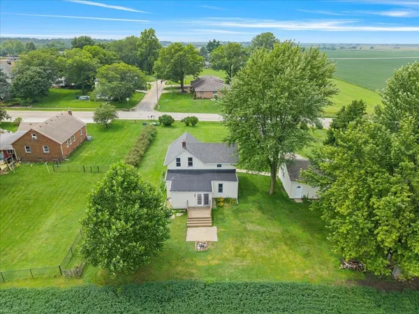 an aerial view of a house with yard swimming pool and outdoor seating