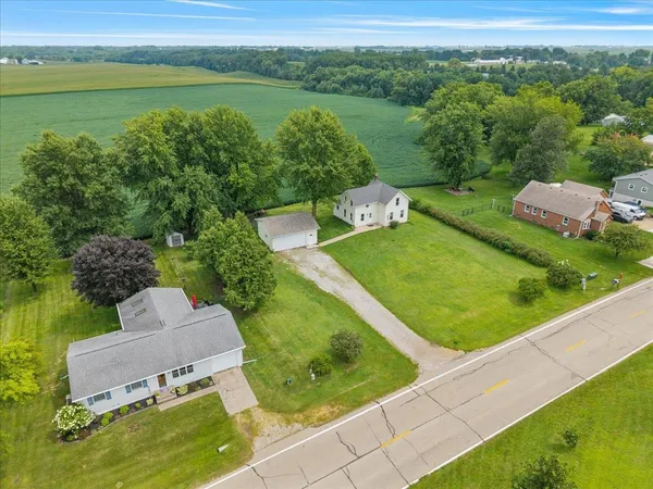 an aerial view of a house with a garden and lake view