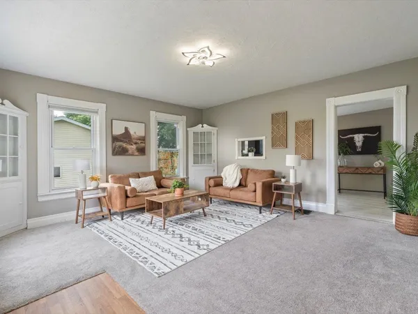a living room with furniture and a chandelier