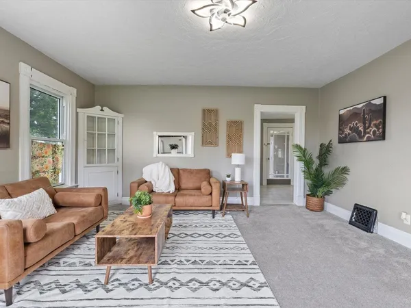 a living room with furniture and a potted plant