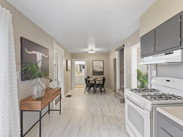 a kitchen with furniture wooden floor and a view of kitchen