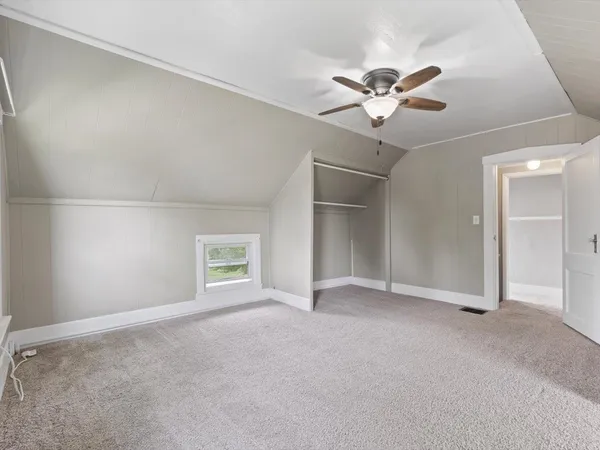 a view of a livingroom with a ceiling fan and window