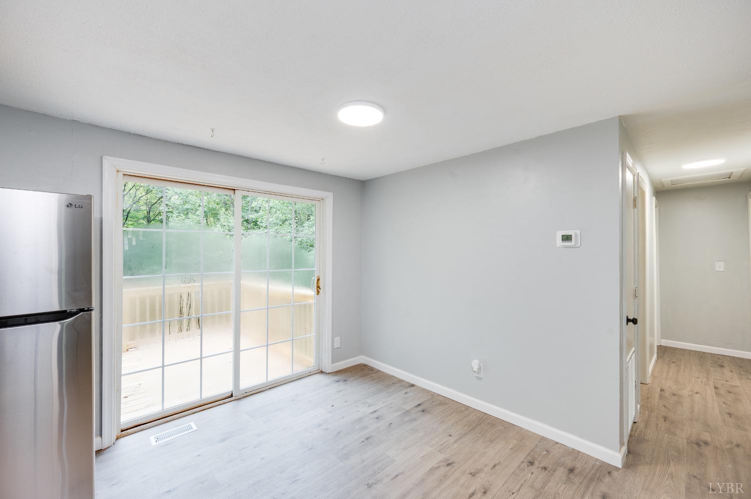 577 Thomas Road Madison Heights, VA 24572 - Photo 12 of 40 a view of an empty room with wooden floor and a window
