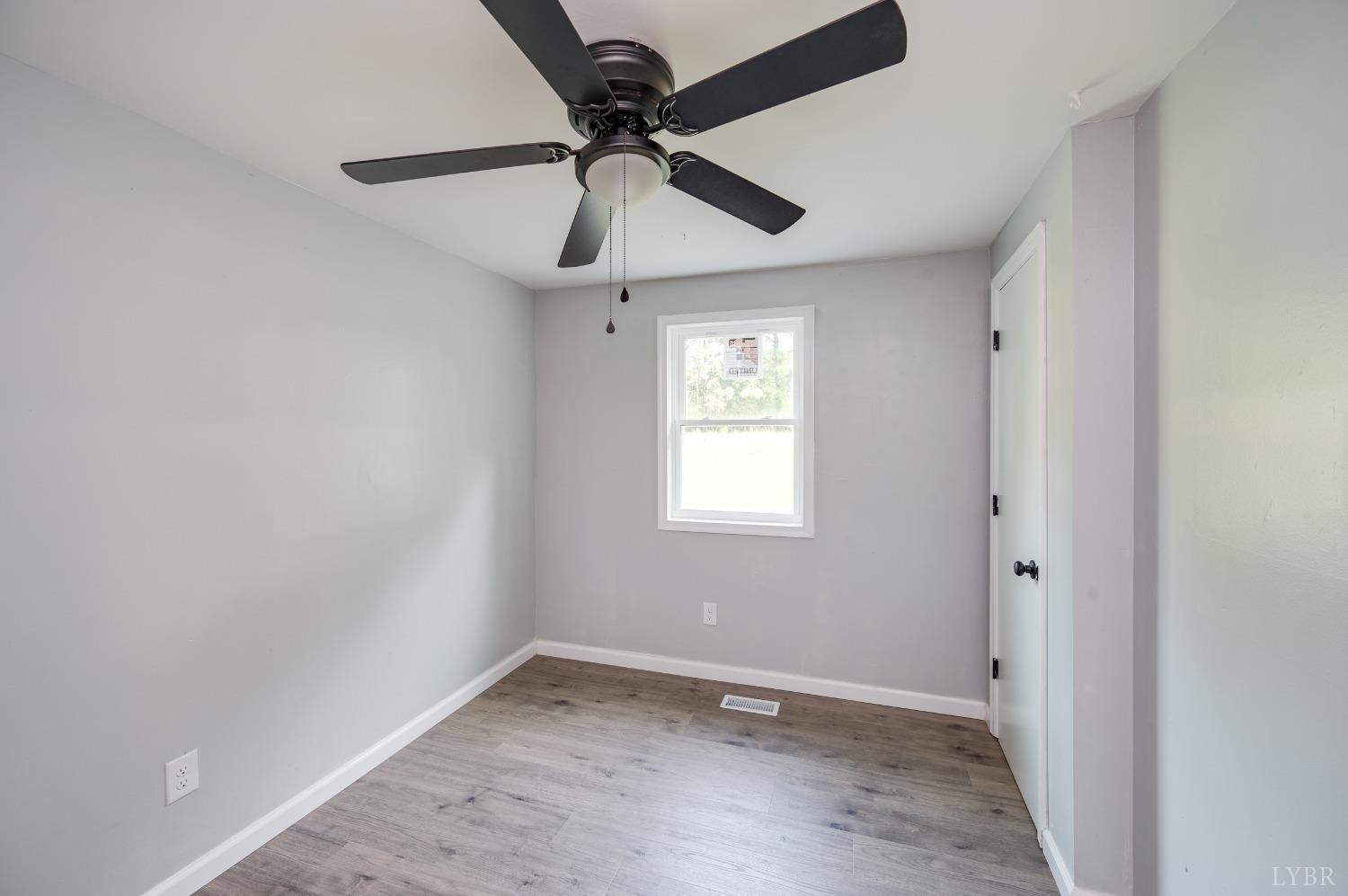 577 Thomas Road Madison Heights, VA 24572 - Photo 14 of 40 an empty room with a window and a fan