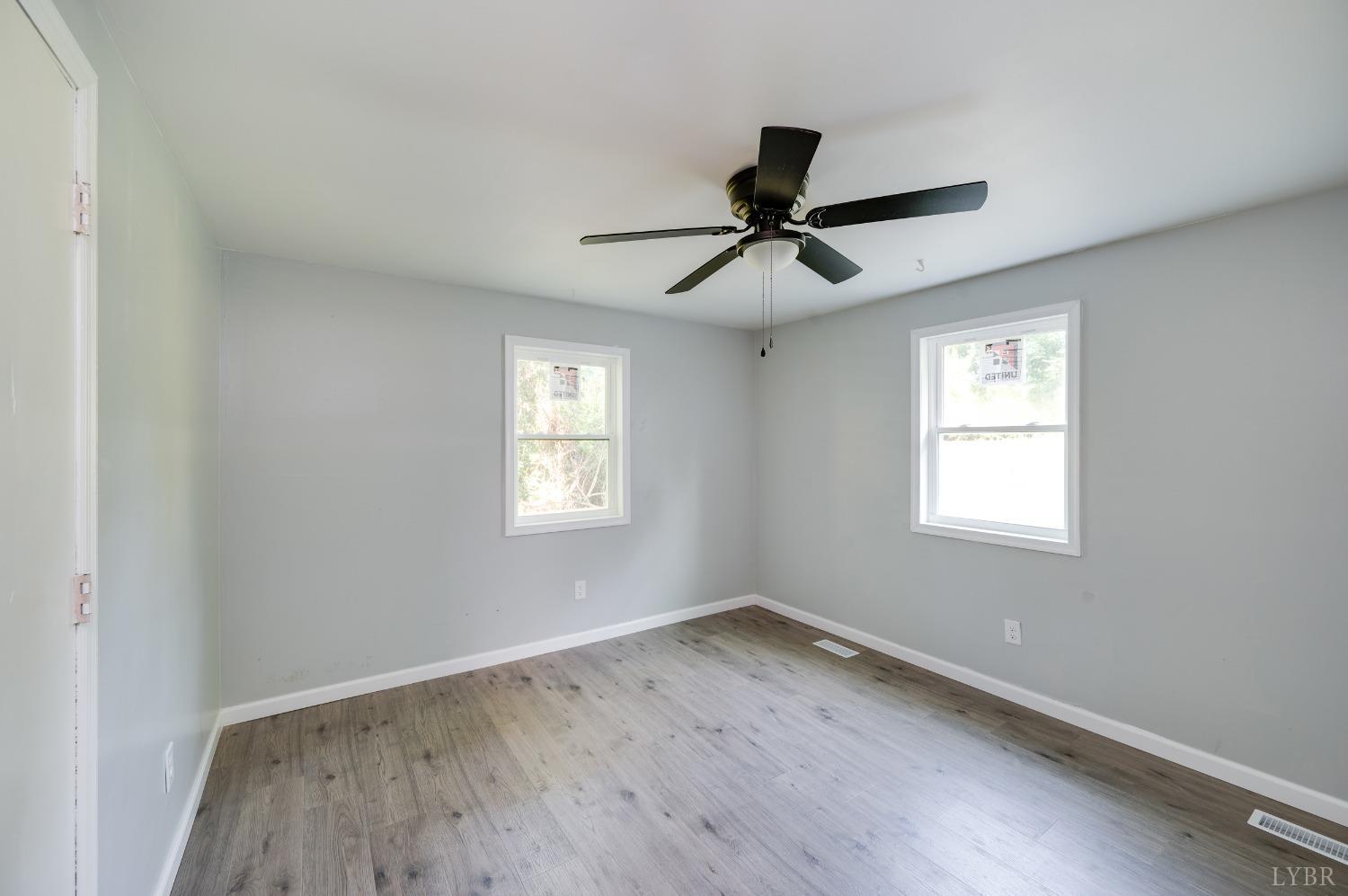 577 Thomas Road Madison Heights, VA 24572 - Photo 18 of 40 a view of empty room with wooden floor and fan