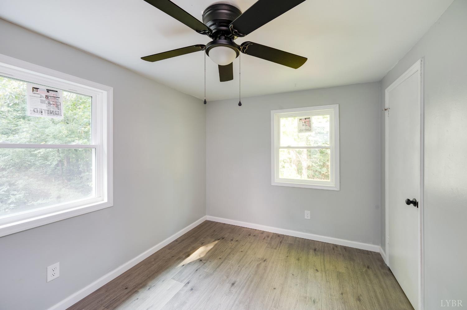 577 Thomas Road Madison Heights, VA 24572 - Photo 20 of 40 a view of empty room with wooden floor and fan