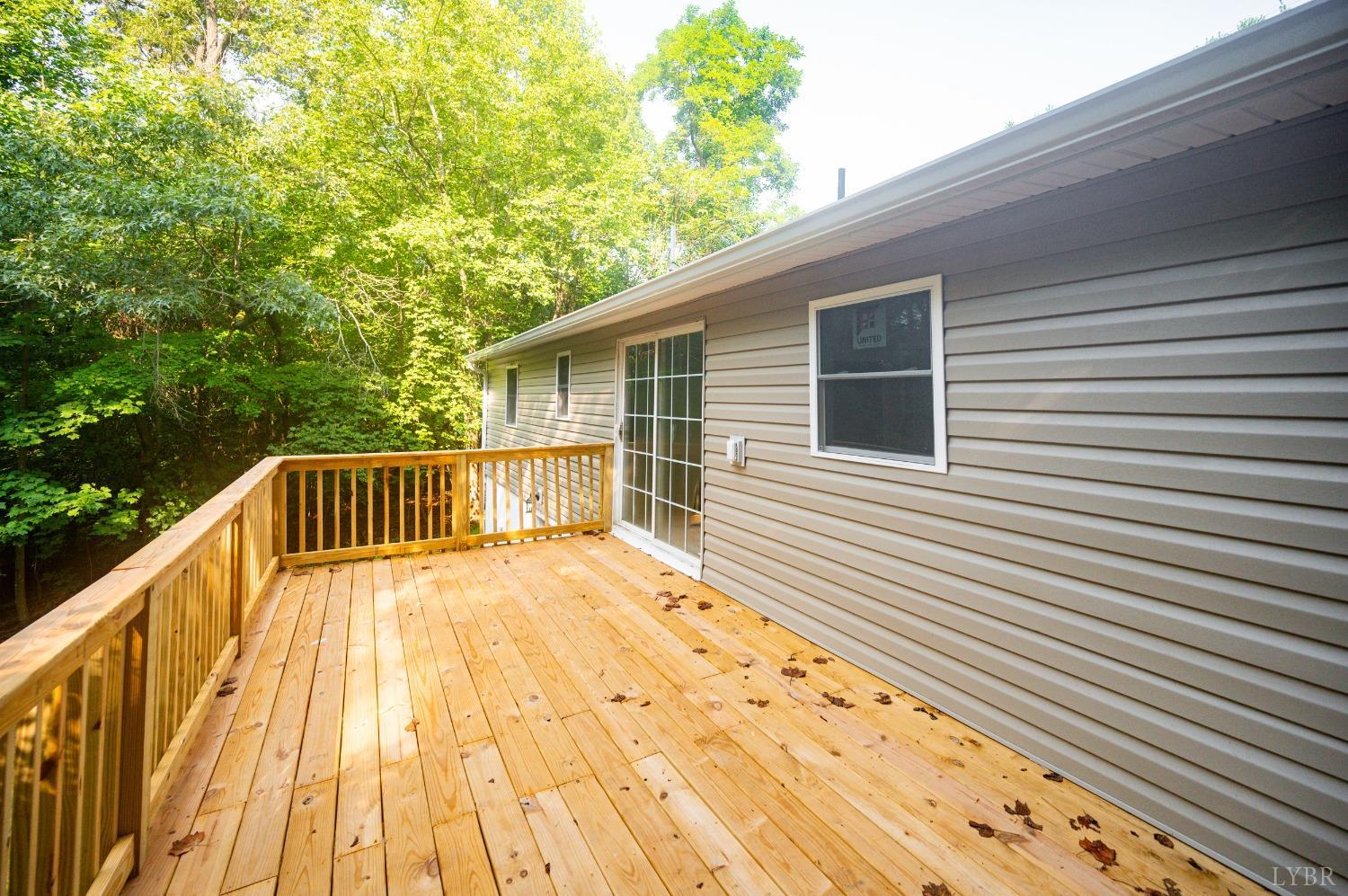 577 Thomas Road Madison Heights, VA 24572 - Photo 26 of 40 a view of deck with wooden floor and fence next to a large window