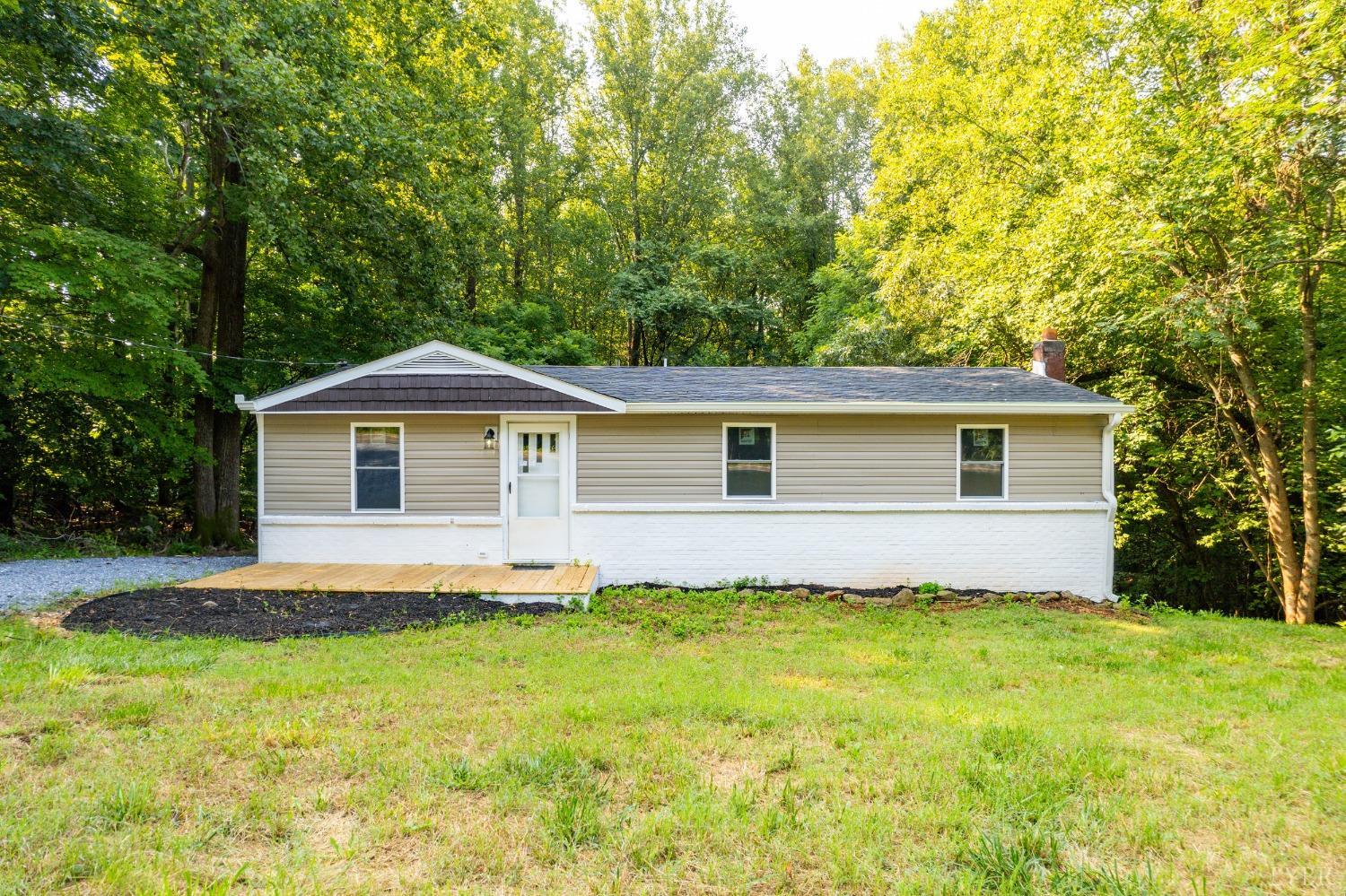 577 Thomas Road Madison Heights, VA 24572 - Photo 27 of 40 a front view of house with yard and trees in the background