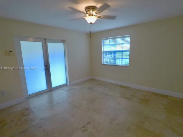a view of a livingroom with a ceiling fan and window