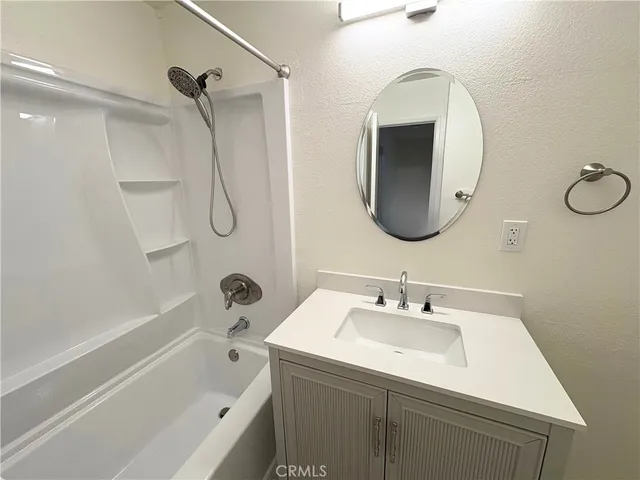 a bathroom with a sink a mirror toilet and bathtub