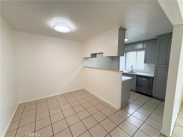 a kitchen with a sink a stove top oven and cabinets