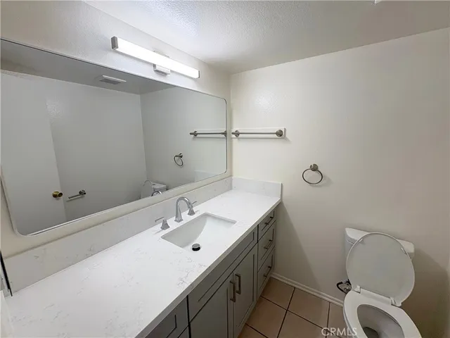 a bathroom with a sink mirror vanity and toilet