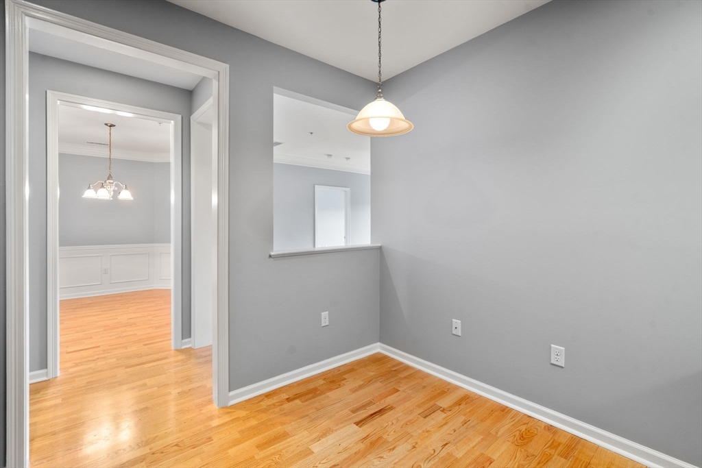 204 Clocktower Drive, Unit 206 Waltham, MA 02452 - Photo 15 of 27 a view of a big room with wooden floor and a bathroom