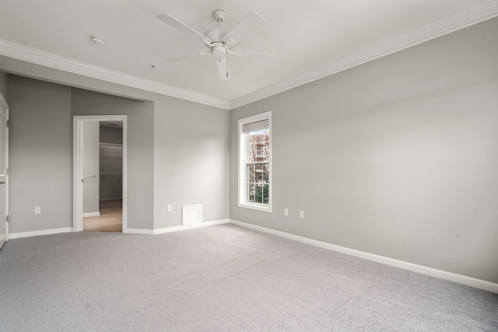 204 Clocktower Drive, Unit 206 Waltham, MA 02452 - Photo 17 of 27 a view of an empty room with a window
