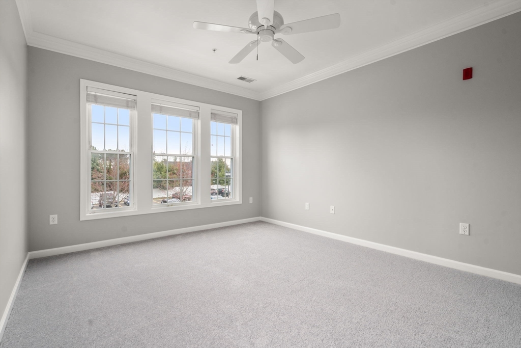 204 Clocktower Drive, Unit 206 Waltham, MA 02452 - Photo 18 of 27 wooden floor in an empty room with a window