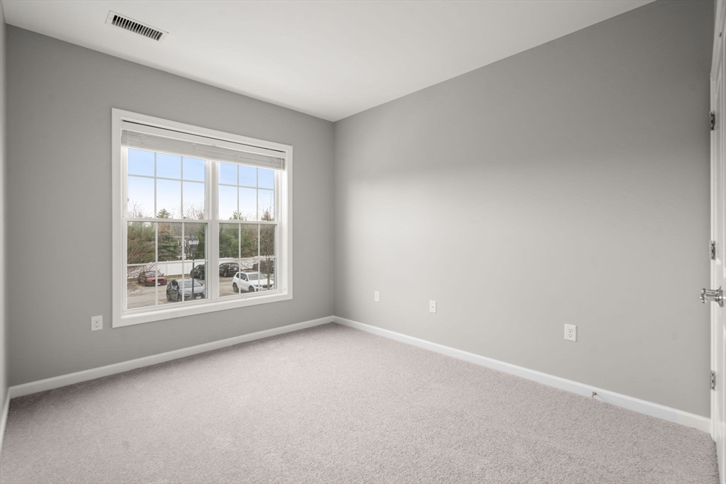 204 Clocktower Drive, Unit 206 Waltham, MA 02452 - Photo 21 of 27 a view of an empty room with a window