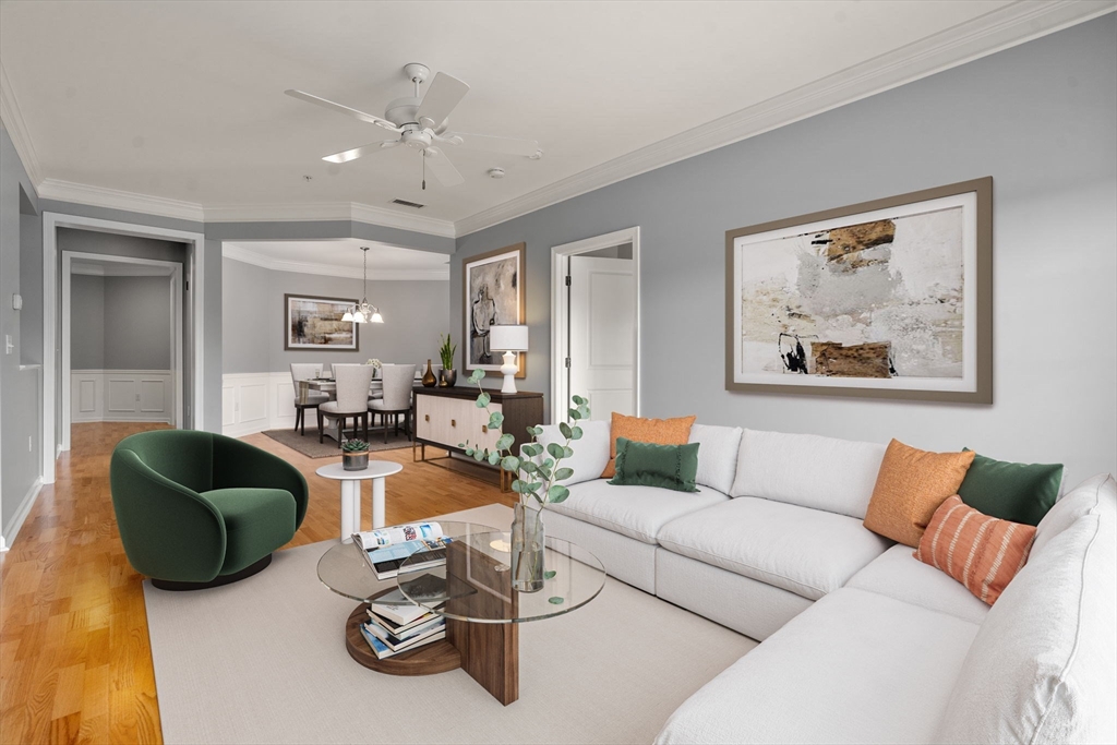 204 Clocktower Drive, Unit 206 Waltham, MA 02452 - Photo 7 of 27 a living room with furniture and a chandelier