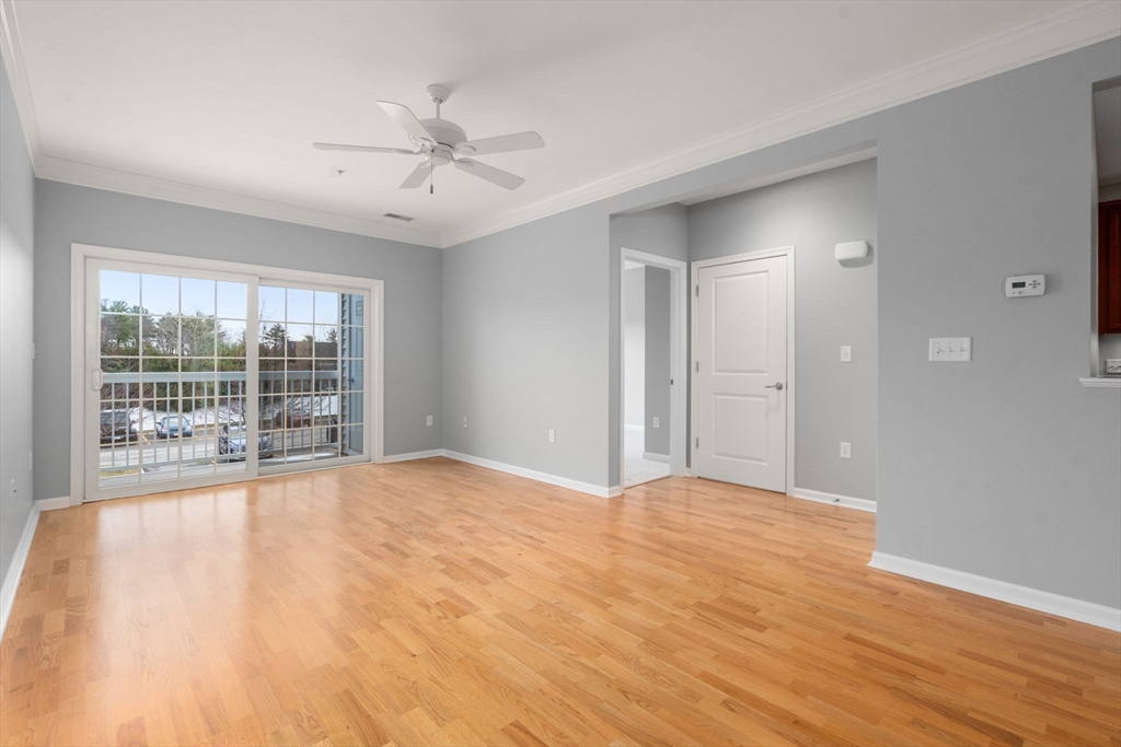 204 Clocktower Drive, Unit 206 Waltham, MA 02452 - Photo 8 of 27 a view of an empty room with wooden floor and a window