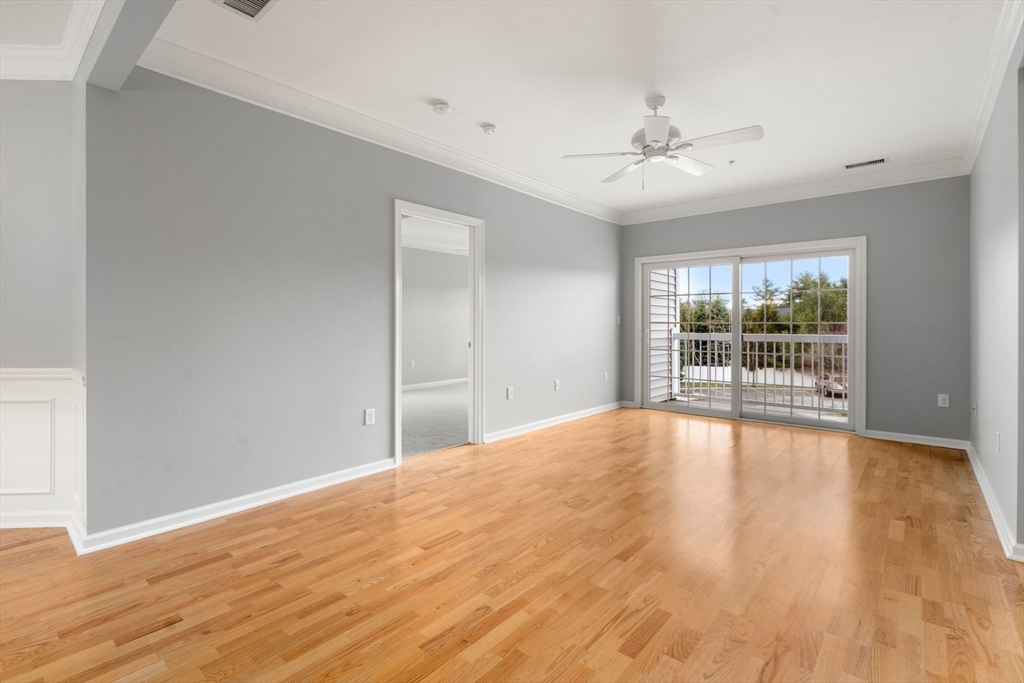 204 Clocktower Drive, Unit 206 Waltham, MA 02452 - Photo 9 of 27 a view of an empty room with wooden floor and a window