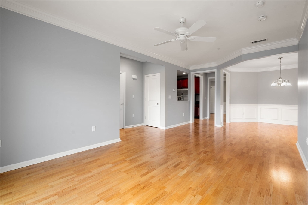 204 Clocktower Drive, Unit 206 Waltham, MA 02452 - Photo 10 of 27 a view of empty room with wooden floor and fan