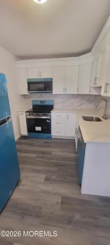 a kitchen with a sink and a stove