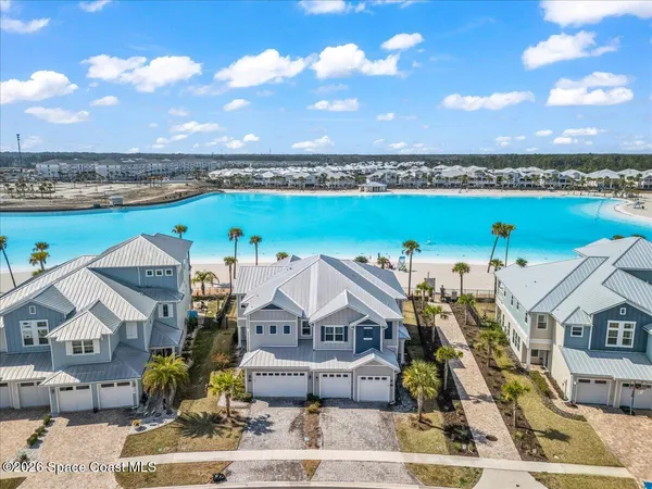 an aerial view of a house with a ocean view