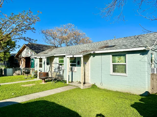 a front view of a house with a yard table and chairs