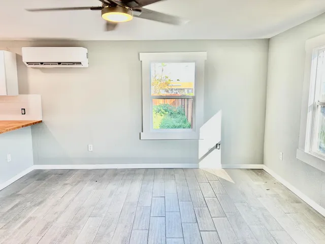 wooden floor in an empty room with a window