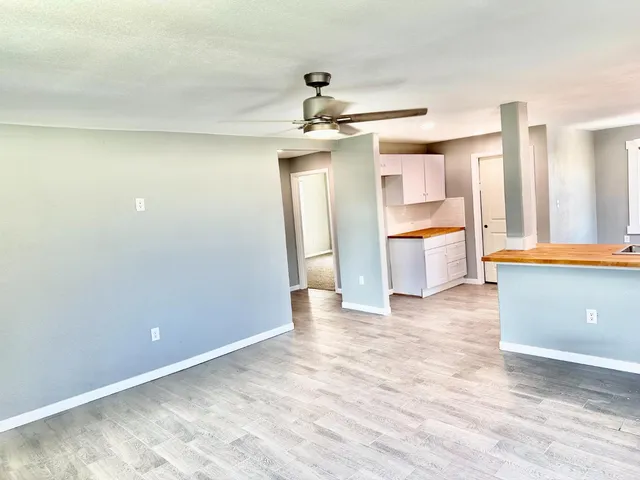 a view of a kitchen with a refrigerator and a sink