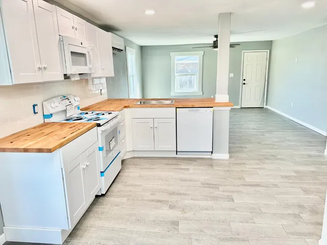 a kitchen with stainless steel appliances granite countertop a sink and a stove