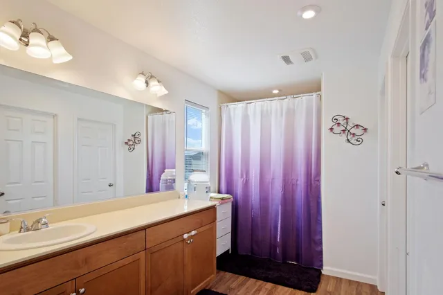a bathroom with a double vanity sink and a mirror