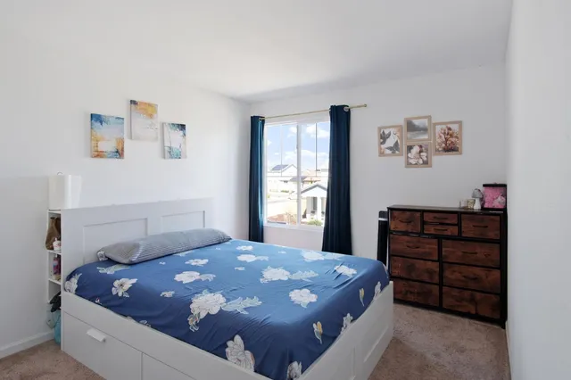 a bedroom with a bed and a window