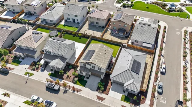an aerial view of a house with a garden and mountain view