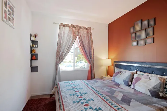 a bedroom with a bed and a window