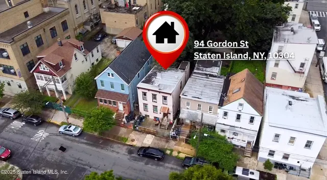 an aerial view of a house with outdoor space and street view