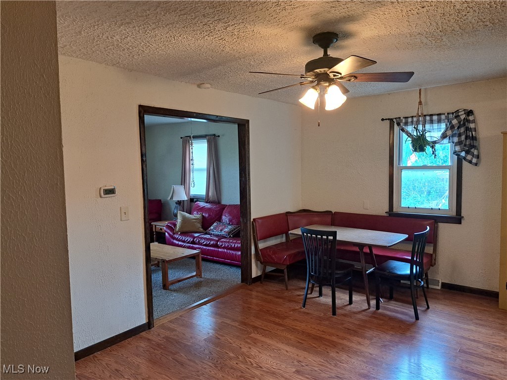 3813 State Road Vermilion, OH 44089 - Photo 13 of 28 Dining room with a textured ceiling, hardwood / wood-style floors, and ceiling fan