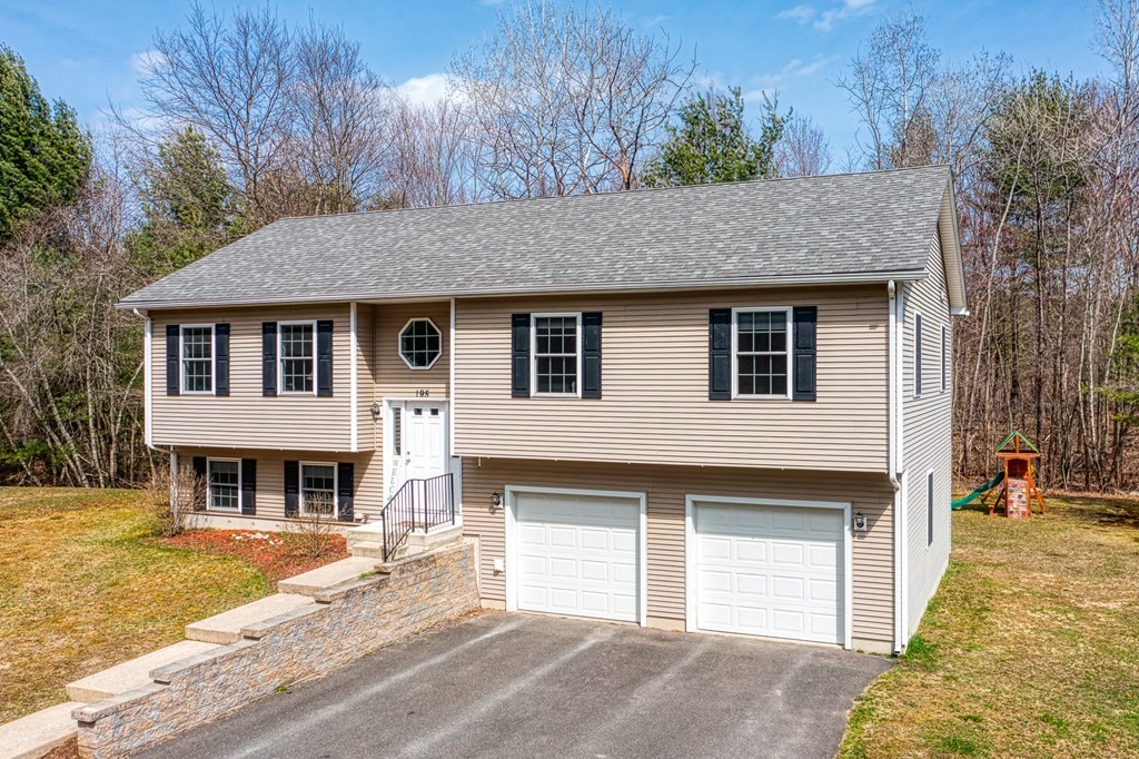 195 Brickyard Road Southampton, MA 01073 - Photo 1 of 42 a front view of a house with a yard garage and outdoor seating