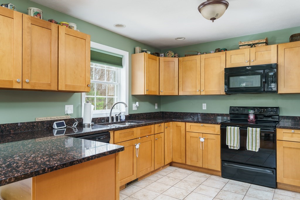195 Brickyard Road Southampton, MA 01073 - Photo 14 of 42 a kitchen with stainless steel appliances granite countertop a sink stove and microwave